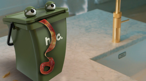Animatie van een groen afvalbakje met oogjes en een appelschil uit zijn mond staat op het aanrecht