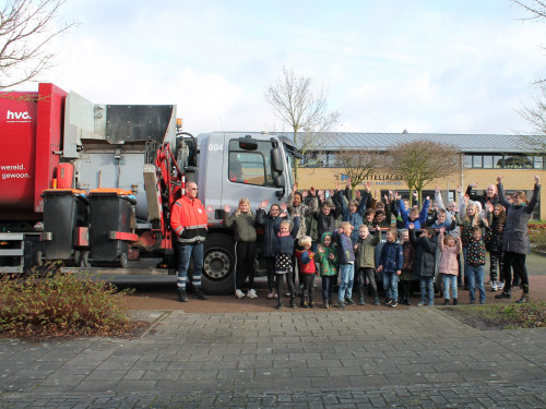 Schoolklas uit Drechterland staat naast de inzamelwagen met chauffeur